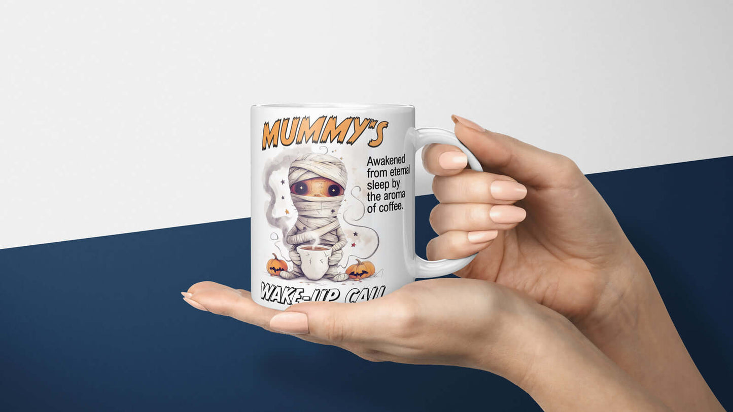 Mummy's Wake-up Call Mug held in hands, featuring a sleepy mummy waking up to the aroma of coffee, perfect for Halloween mornings.
