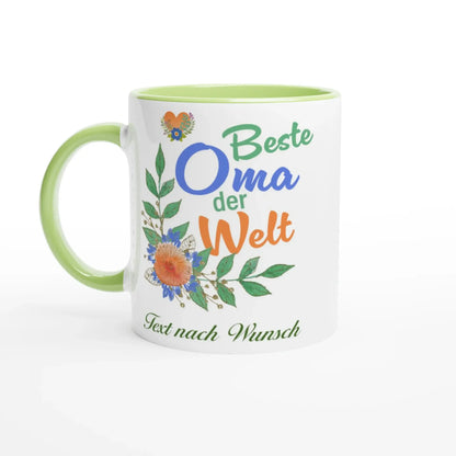A charming Beste Oma der Welt Tasse from Tasse mit Herz features a green handle and vibrant flowers, customizable with your text, making it an ideal gift for grandma.