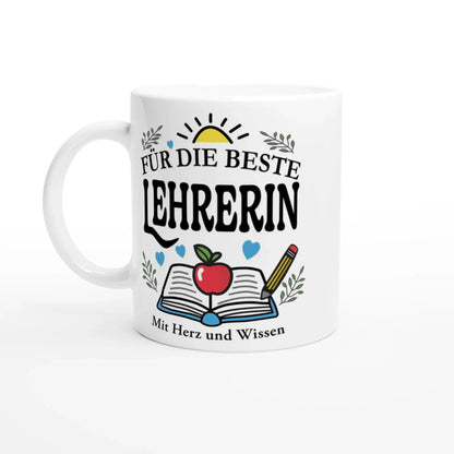 The Tasse „Für die beste Lehrerin“ by Tasse mit Herz features a design with a sun, open book, apple, pencil, hearts, and leaves. Its the perfect Geschenk for inspiring educators and includes the phrase Mit Herz und Wissen at the bottom.