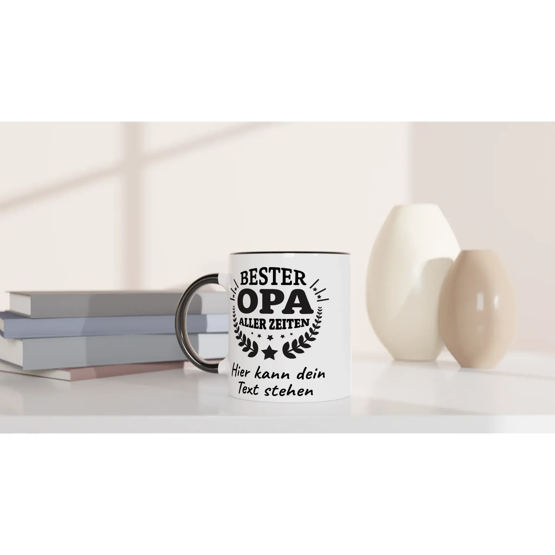 A white personalisierte Tasse from Tasse mit Herz, featuring the text Bester Opa aller Zeiten and Hier kann dein Text stehen in black, sits on a white surface near books and vases, making it an ideal Geschenk. The softly blurred background enhances its appeal for any occasion.
