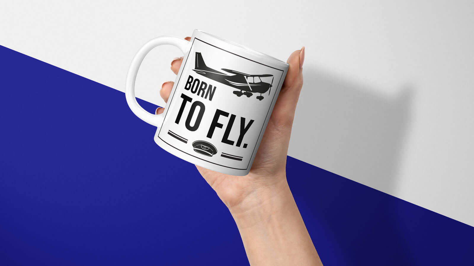 Hand holding "Born to fly" mug with airplane design, perfect for pilots and aviation enthusiasts seeking adventure and inspiration.